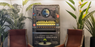 Staying on Top of Trends Lowell joint and pre-roll vending machine inside a dispensary waiting room with two mid century modern chairs and plants