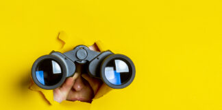 Why Dispensaries and Brands Need Effective Secret Shopper Programs Female popping through a yellow banner with binoculars to spy as a secret shopper