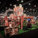 Video showcasing the LuvBuds University-themed trade show exhibit at MJBizCon 2024, featuring creative brick architecture, vibrant product displays, and an immersive educational atmosphere.