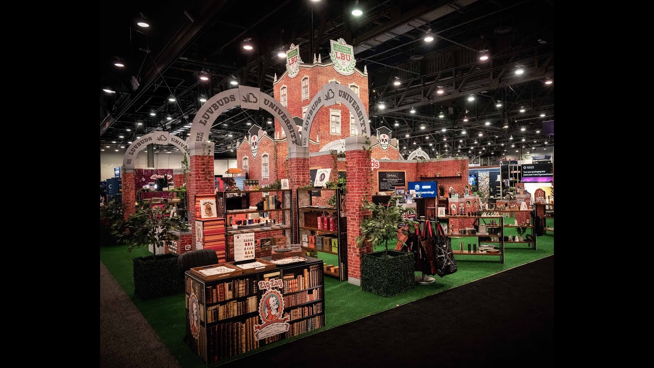 Video showcasing the LuvBuds University-themed trade show exhibit at MJBizCon 2024, featuring creative brick architecture, vibrant product displays, and an immersive educational atmosphere.