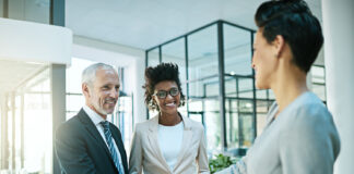 Resolving Disputes without Lawsuits Business professionals shaking hands in an office, symbolizing successful dispute resolution through mediation.