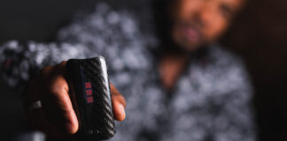 2025’s Must-Have Vapes: Top Brands & Game-Changing Tech Close-up of a person holding a DaVinci vaporizer with a carbon fiber finish, showcasing its sleek design and LED display.