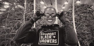 Why Women Are the Power Players in Cannabis — As Consumers and Entrepreneurs Rebecca Colett, CEO of Calyxeum, smiling in a cannabis cultivation facility while wearing a "Support Black Growers" hoodie.
