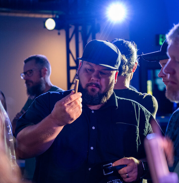 Man inspects a freshly rolled blunt during RollPros Blackbird XXL product demo