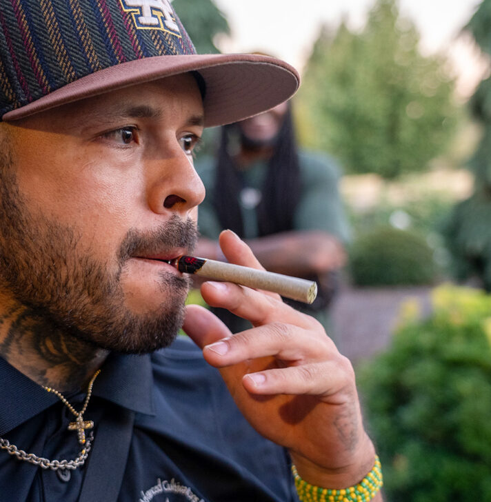 Man smokes a blunt rolled by the RollPros Blackbird XXL at launch event