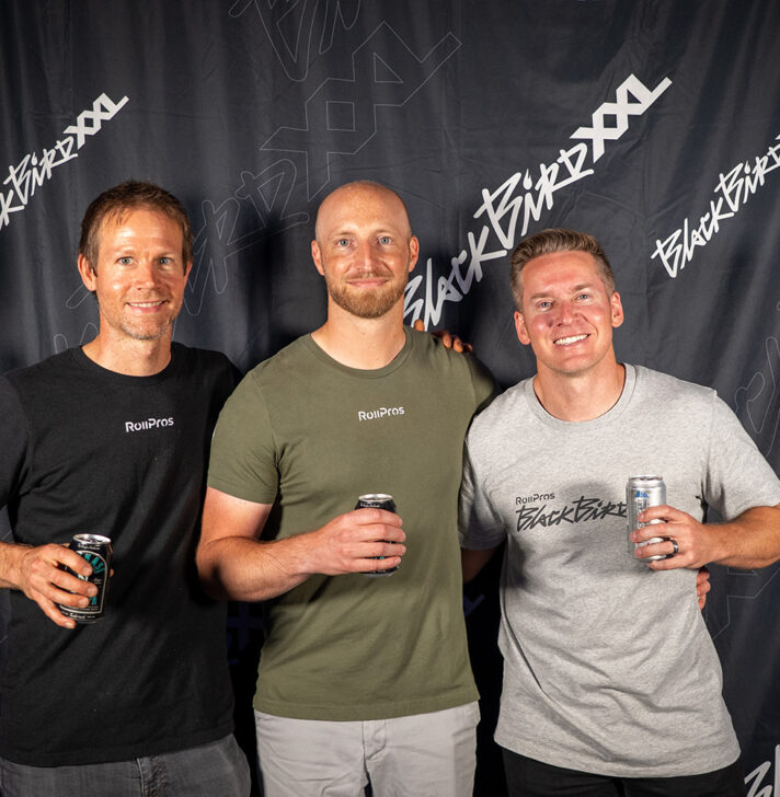 Three RollPros team members pose in front of Blackbird XXL event backdrop