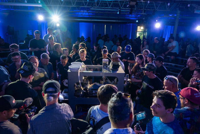 Attendees watch live demo of RollPros Blackbird XXL blunt-rolling machine