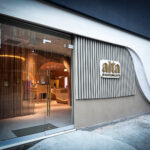 Alta Brings Family Legacy and Feminine Wellness to NYC Dispensary Alta Dispensary storefront in Nolita-Chinatown, New York City, featuring modern architectural elements and a curved wall design with illuminated signage.