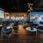 How Cannabis Retailers Are Diversifying Marketing for Growth The Artist Tree’s cannabis consumption lounge featuring elegant seating, art-covered walls, and a modern bar setup.