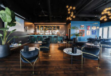 How Cannabis Retailers Are Diversifying Marketing for Growth The Artist Tree’s cannabis consumption lounge featuring elegant seating, art-covered walls, and a modern bar setup.