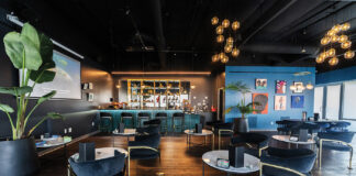 How Cannabis Retailers Are Diversifying Marketing for Growth The Artist Tree’s cannabis consumption lounge featuring elegant seating, art-covered walls, and a modern bar setup.