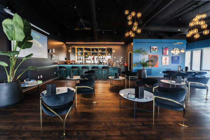 The Artist Tree’s cannabis consumption lounge featuring elegant seating, art-covered walls, and a modern bar setup.