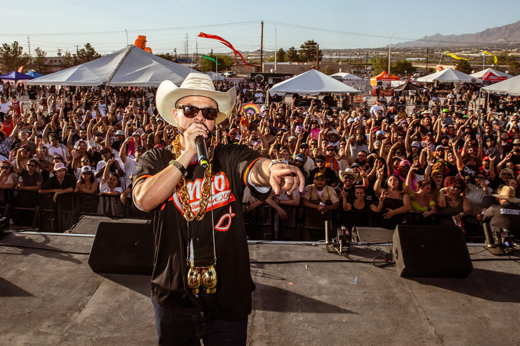 Performer engaging the crowd during Mango Del Sol, Mango Cannabis’s large-scale concert event in Sunland Park, New Mexico.