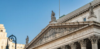 NY Supreme Court Blocks OCM from Closing Licensed Dispensaries New York State Supreme Court building in Manhattan with inscription emphasizing justice, related to injunction blocking OCM dispensary closures.