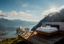 CBN: The Cannabinoid Redefining Natural Sleep Solutions Scenic outdoor bedroom overlooking mountain lake at sunrise, symbolizing natural and holistic sleep environments inspired by wellness practices.