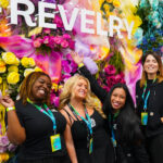 Revelry 2025: New York’s Cannabis Market Finds Its Stride Group of women posing in front of a colorful flower wall at Revelry 2025 cannabis trade show in New York City
