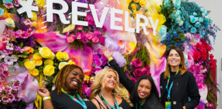 Revelry 2025: New York’s Cannabis Market Finds Its Stride Group of women posing in front of a colorful flower wall at Revelry 2025 cannabis trade show in New York City
