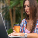 4 Restriction-Proof Ways to Get Cannabis Content Seen Digital marketer working on a laptop, illustrating resilient outreach and content distribution strategies for cannabis brands operating under advertising restrictions.