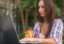 4 Restriction-Proof Ways to Get Cannabis Content Seen Digital marketer working on a laptop, illustrating resilient outreach and content distribution strategies for cannabis brands operating under advertising restrictions.