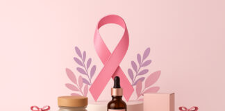 Cannabis Brands Making an Impact on Breast Cancer Awareness Pink breast cancer awareness ribbon surrounded by cannabis products, including flower, pre-rolls, and tincture bottles on a soft pink background.