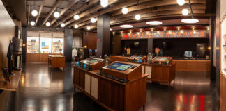 Klutch Cannabis Revives Cleveland’s Musical Landmark Wide-angle view of Klutch Cannabis retail floor featuring interactive display islands and product showcases in Cleveland dispensary.