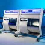 Mobius: Automation that Pays for Itself, Maximizing ROI Two Mobius M108S Trimmers in tandem configuration with conveyor system, designed for high-volume cannabis post-harvest automation.