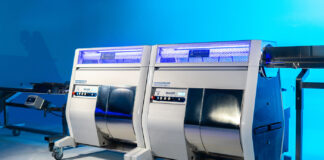 Mobius: Automation that Pays for Itself, Maximizing ROI Two Mobius M108S Trimmers in tandem configuration with conveyor system, designed for high-volume cannabis post-harvest automation.