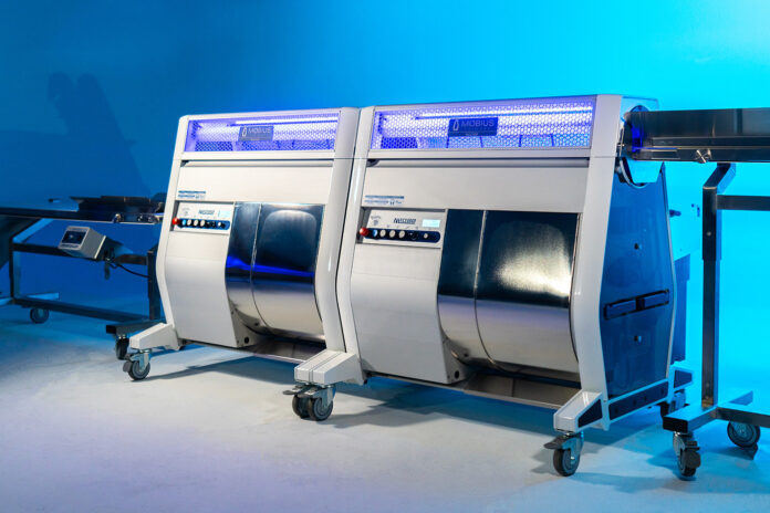 Two Mobius M108S Trimmers in tandem configuration with conveyor system, designed for high-volume cannabis post-harvest automation.