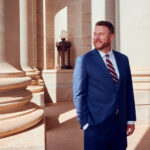 How Brian Ted Jones Helped Shape Oklahoma’s Cannabis Industry Attorney Brian Ted Jones standing outside a courthouse-style building with stone columns in Oklahoma, representing cannabis industry legal counsel.