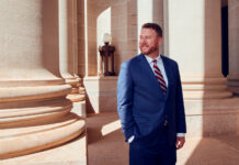 How Brian Ted Jones Helped Shape Oklahoma’s Cannabis Industry Attorney Brian Ted Jones standing outside a courthouse-style building with stone columns in Oklahoma, representing cannabis industry legal counsel.