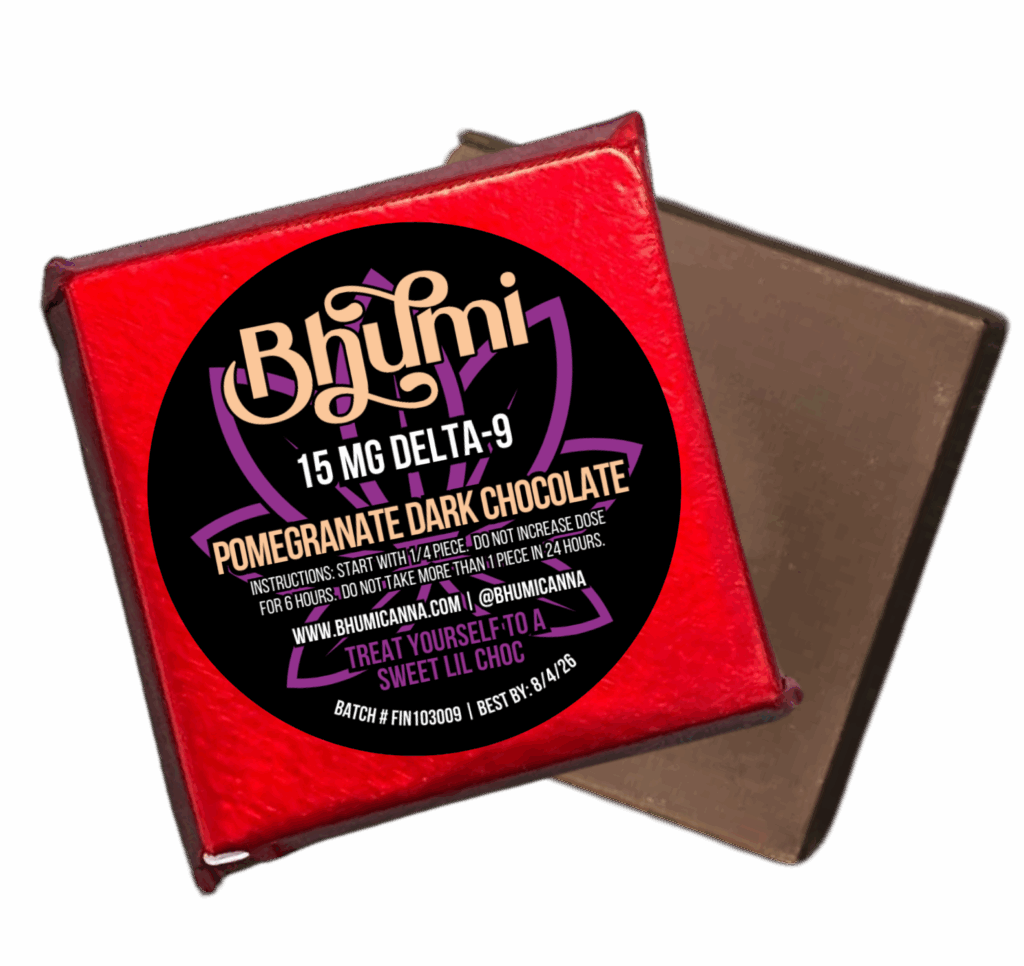 Bhūmi pomegranate dark chocolate square wrapped in red foil with branded label on top, shown next to an unwrapped chocolate piece.