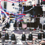 Automation for a New Era of Cannabis Pre-Roll Manufacturing High-precision Hefestus automation system used for advanced pre-roll manufacturing, featuring enclosed controls and illuminated internal components.