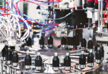 Automation for a New Era of Cannabis Pre-Roll Manufacturing High-precision Hefestus automation system used for advanced pre-roll manufacturing, featuring enclosed controls and illuminated internal components.