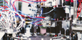 Automation for a New Era of Cannabis Pre-Roll Manufacturing High-precision Hefestus automation system used for advanced pre-roll manufacturing, featuring enclosed controls and illuminated internal components.