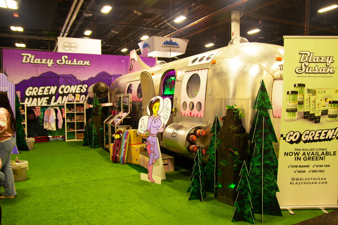Blazy Susan’s Airstream-themed booth at MJBizCon 2025 featuring pre-rolled green cones and accessories.