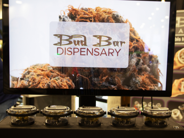 Bud Bar Dispensary display at MJBizCon 2025 showing cannabis flower in scent jars.