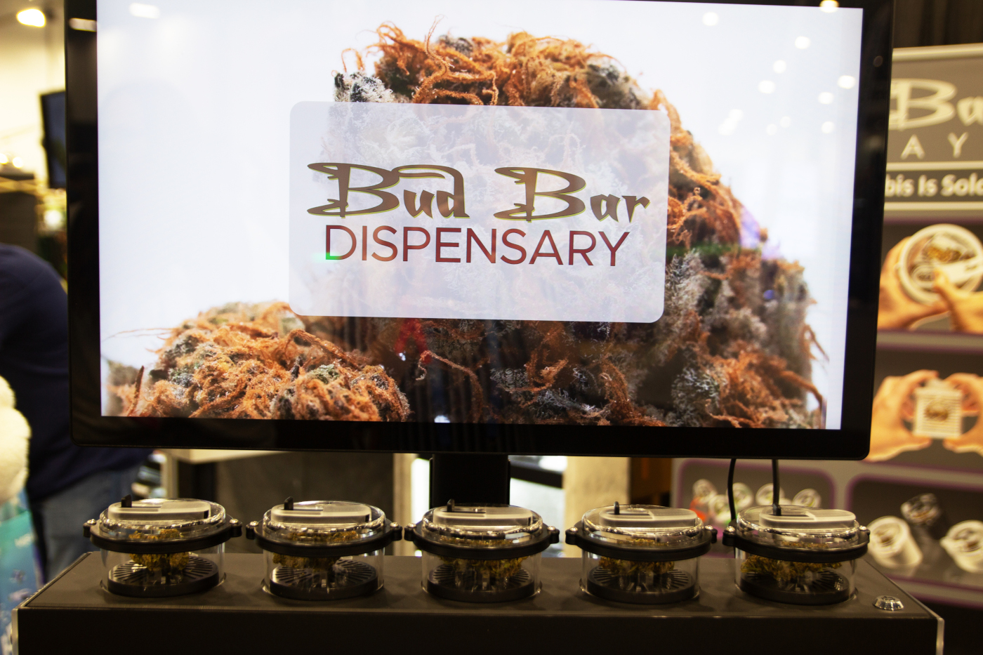 Bud Bar Dispensary display at MJBizCon 2025 showing cannabis flower in scent jars.