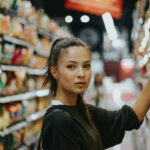 2026 Cannabis Marketing Playbook: Consumer Shifts You Can’t Ignore A shopper evaluates products in a retail aisle, illustrating the data-driven, wellness-focused decision-making shaping cannabis consumer behavior in 2026.