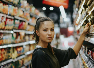 2026 Cannabis Marketing Playbook: Consumer Shifts You Can’t Ignore A shopper evaluates products in a retail aisle, illustrating the data-driven, wellness-focused decision-making shaping cannabis consumer behavior in 2026.