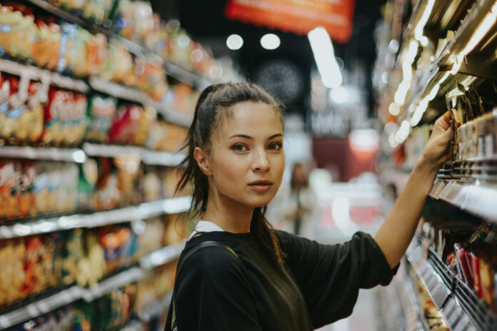 How cannabis consumers shop in 2026 A shopper evaluates products in a retail aisle, illustrating the data-driven, wellness-focused decision-making shaping cannabis consumer behavior in 2026.