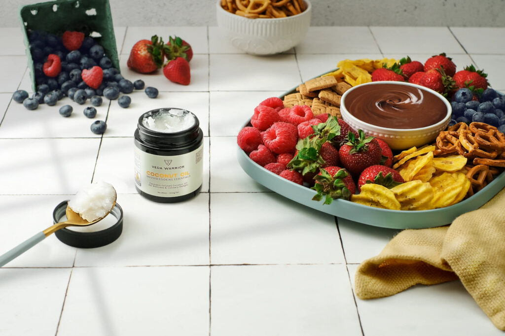 Cannabis-infused coconut oil styled with fruit and snacks as part of a winter self-care ritual.