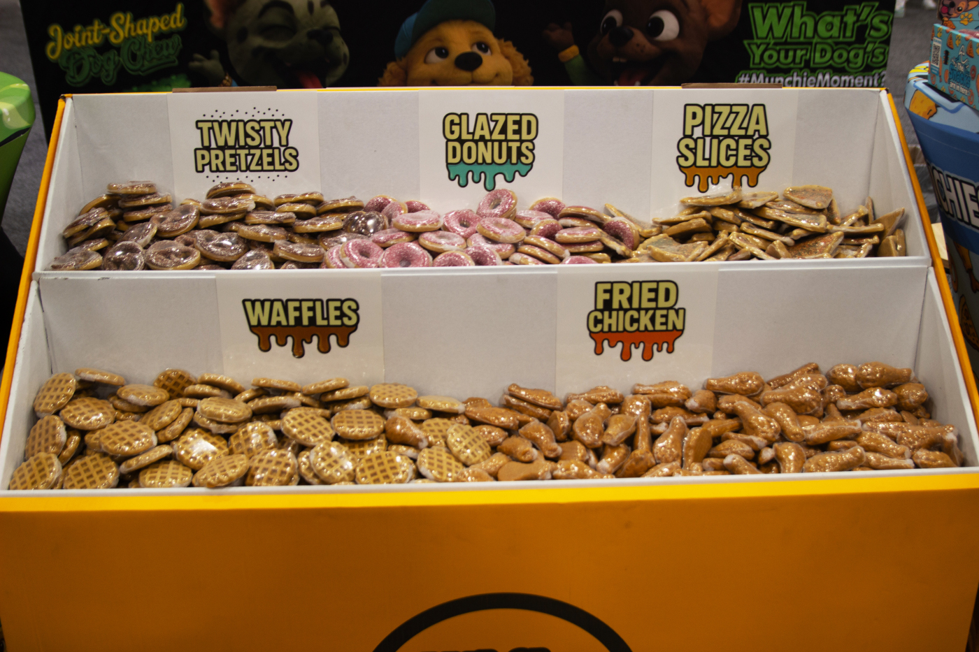 Munchies cannabis-themed dog treats shaped like pretzels, donuts, waffles, pizza slices, and chicken at MJBizCon 2025.