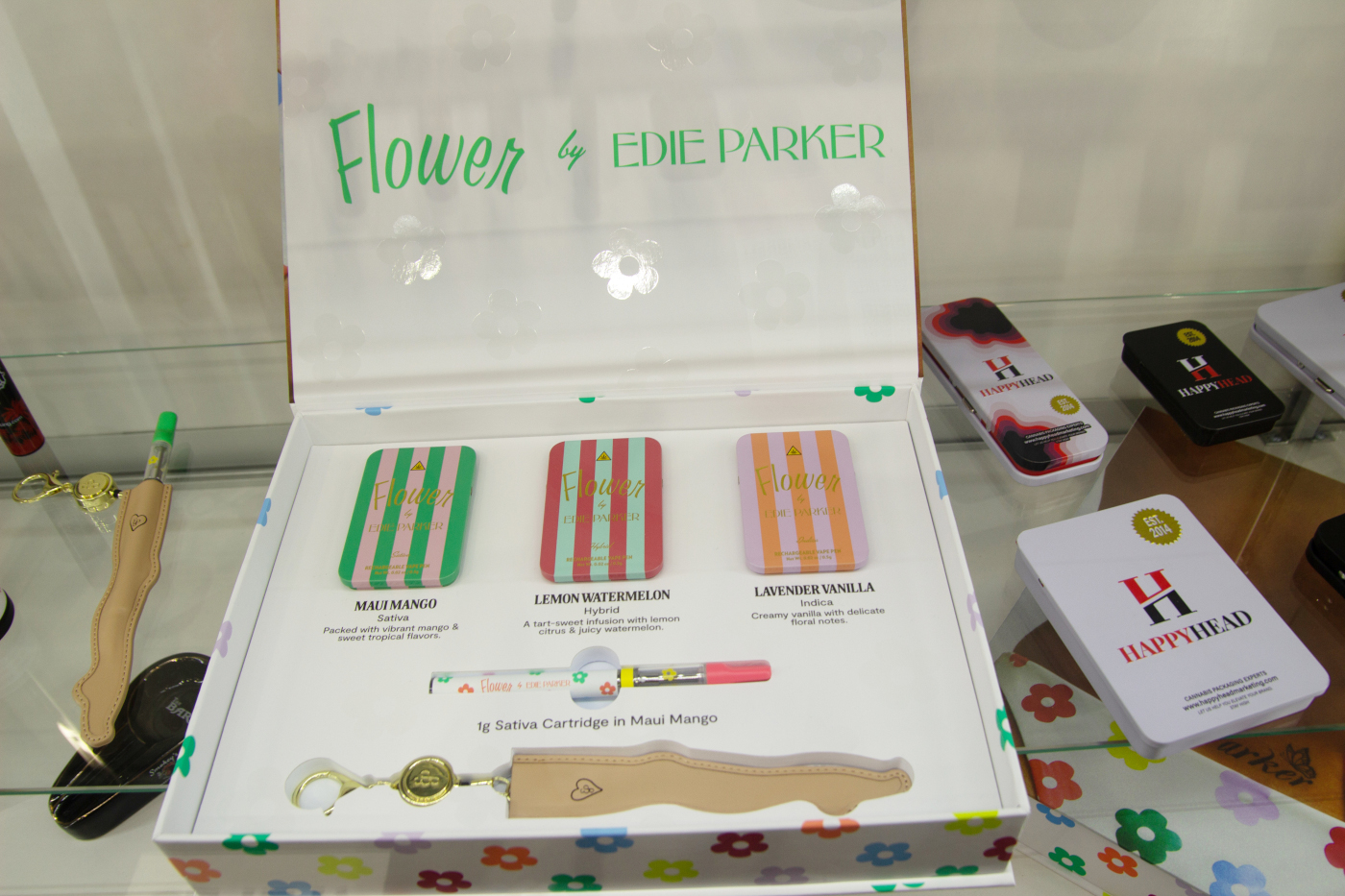 Flower by Edie Parker cannabis packaging and vape cartridge displayed at MJBizCon 2025.