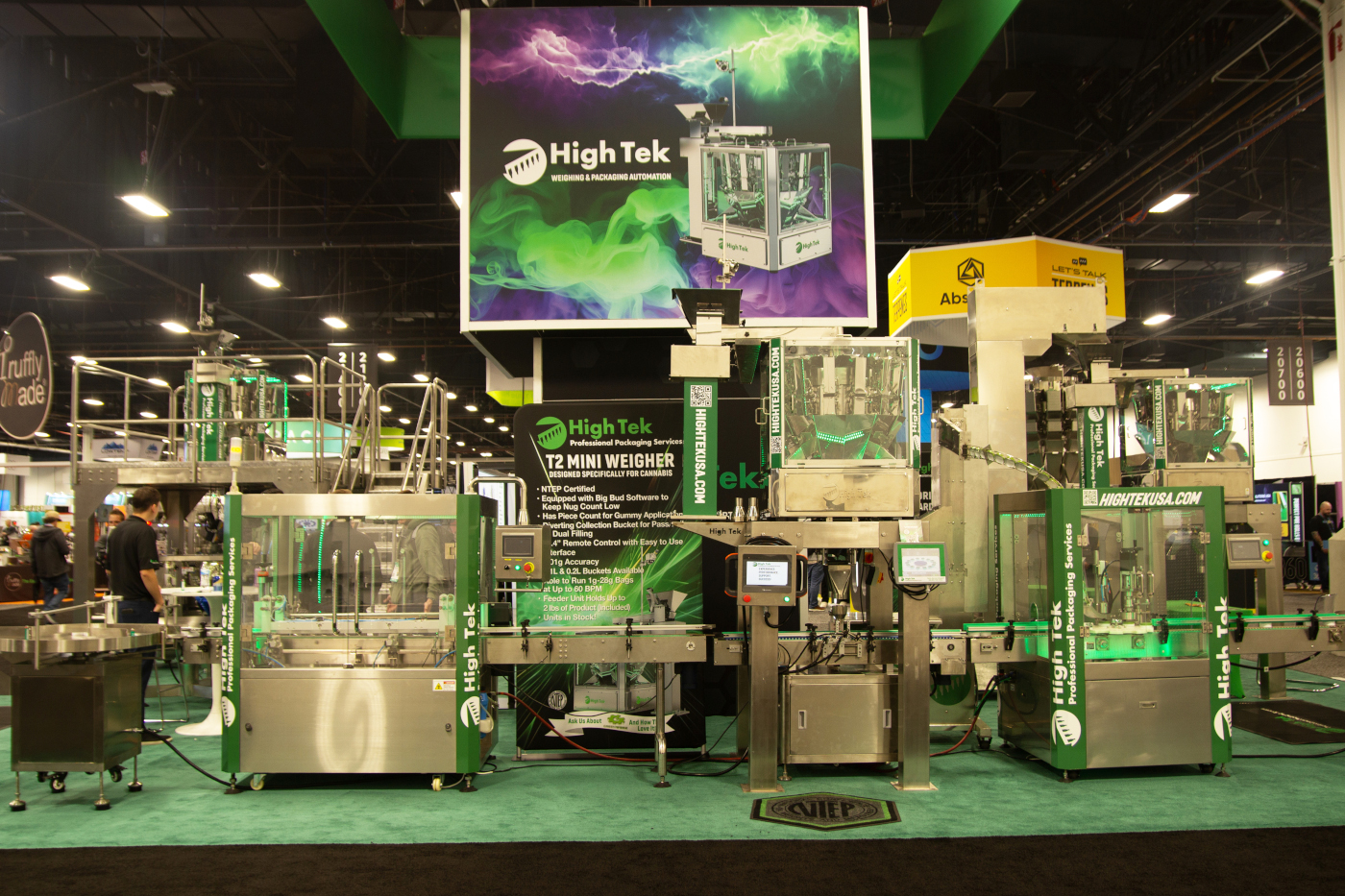 High Tek booth showcasing automated cannabis packaging and weighing systems at MJBizCon 2025.