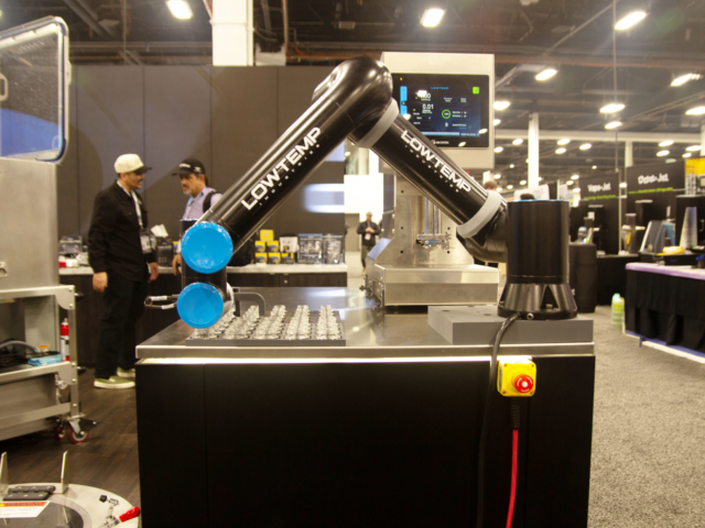 LowTemp Industries robotic arm for automated rosin extraction on display at MJBizCon 2025.