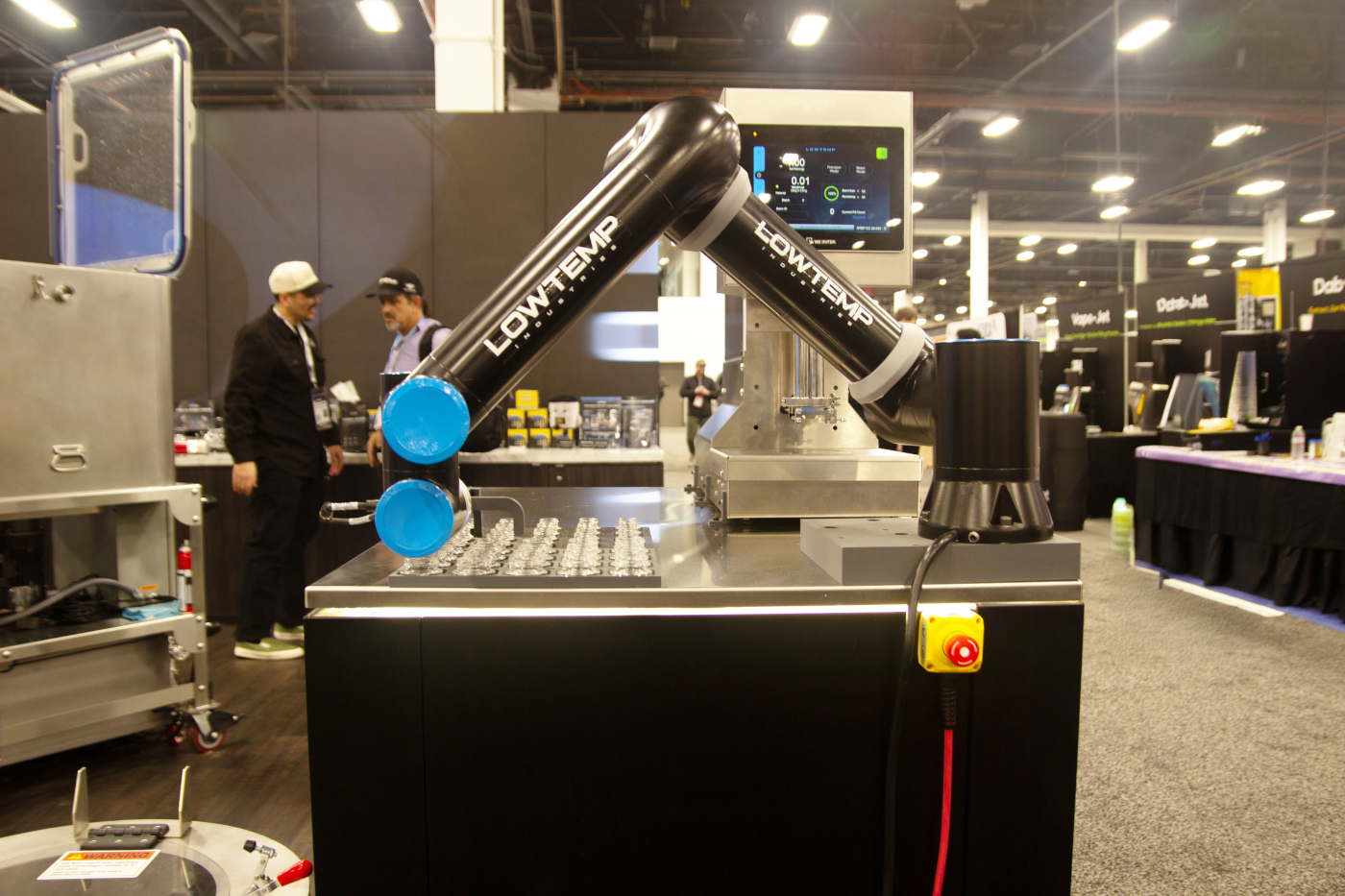 LowTemp Industries robotic arm for automated rosin extraction on display at MJBizCon 2025.