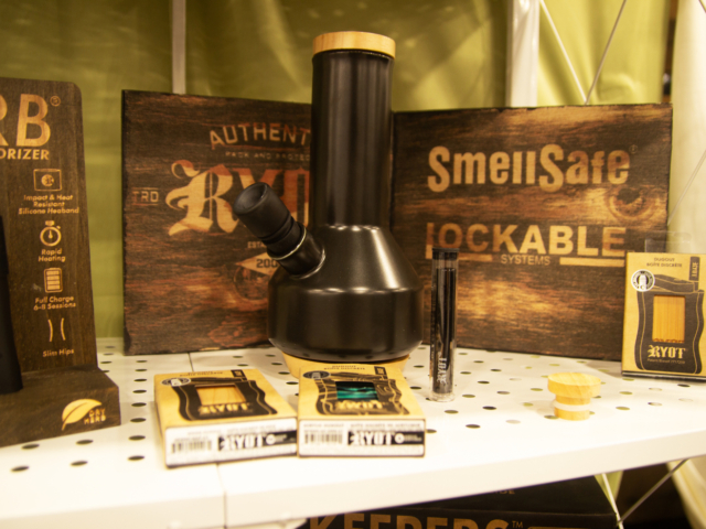 RYOT display featuring cannabis smoking accessories and SmellSafe lockable storage solutions at MJBizCon 2025.