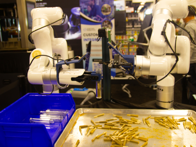 Sorting Robotics' robotic arms sorting and packaging cannabis pre-rolls at MJBizCon 2025.
