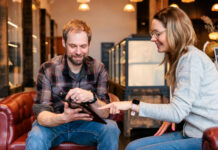 Beyond the Transaction: Empathy and Simplicity in Cannabis Retail A budtender and customer sitting on a couch in a modern dispensary, demonstrating a simplified and empathetic cannabis retail experience.