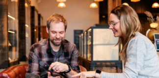 Beyond the Transaction: Empathy and Simplicity in Cannabis Retail A budtender and customer sitting on a couch in a modern dispensary, demonstrating a simplified and empathetic cannabis retail experience.